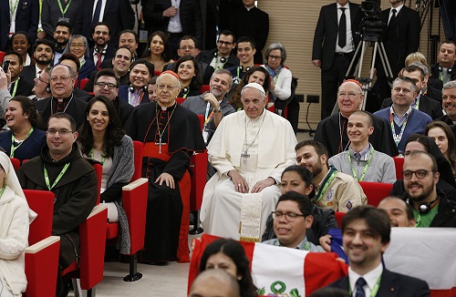 Pope Francis poses for a photo at a pre-synod gathering of youth delegates at the Pontifical International Maria Mater Ecclesiae College in Rome March 19. The meeting was in preparation for the Synod of Bishops on young people, the faith and vocational discernment this October at the Vatican. Seated next to the pope are Cardinal Lorenzo Baldisseri, secretary-general of the Synod of Bishops, and U.S. Cardinal Kevin J. Farrell, prefect of the Vatican's Dicastery for Laity, Family and Life.(CNS photo/Paul Haring) See POPE-YOUTH-PRESYNOD March 19, 2018.