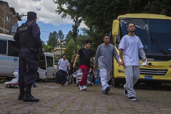 Two buses of approximately 50 deportees from the United States are moved into the Center for Migration in San Salvador. (Jesse Costa/WBUR)